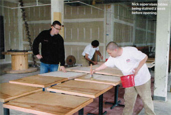 Nick supervises tables being stained a week before opening.